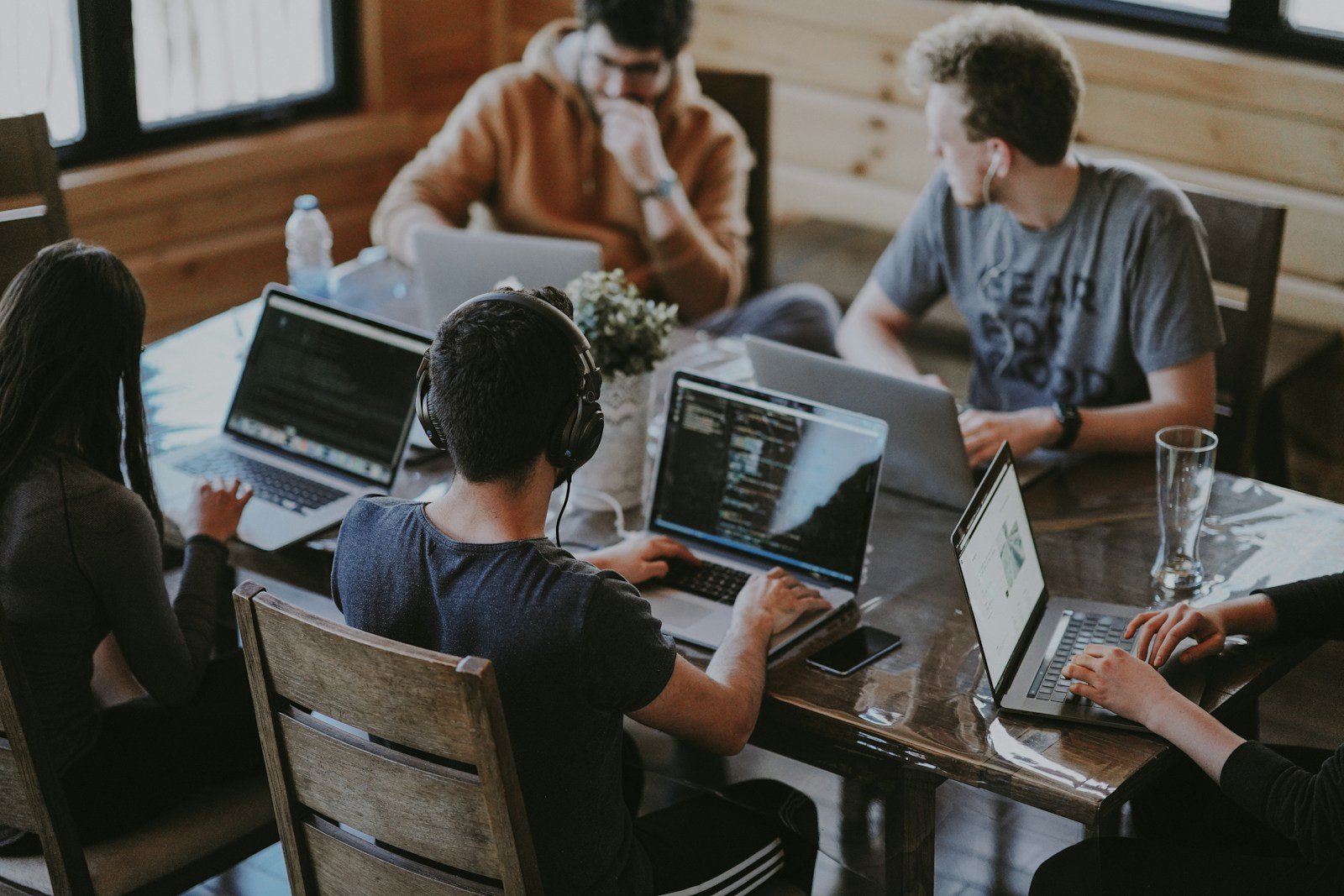 Creative collaboration around a table with laptops